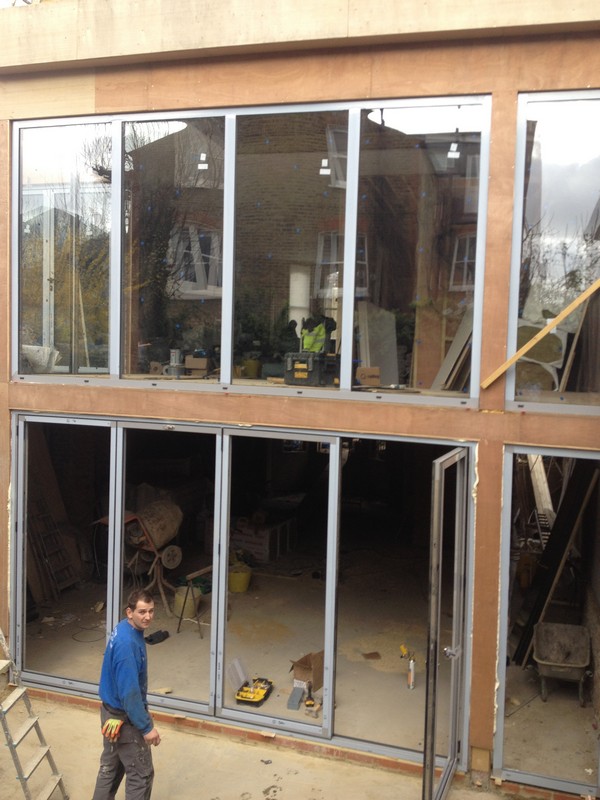 Aluminium bi-fold doors with two-storey glazing in Muswell Hill
