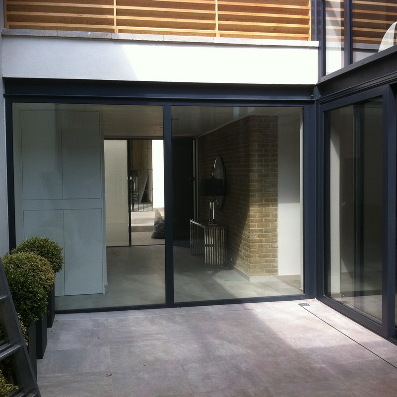 Floor-to-ceiling sliding doors opening to courtyard in Muswell Hill