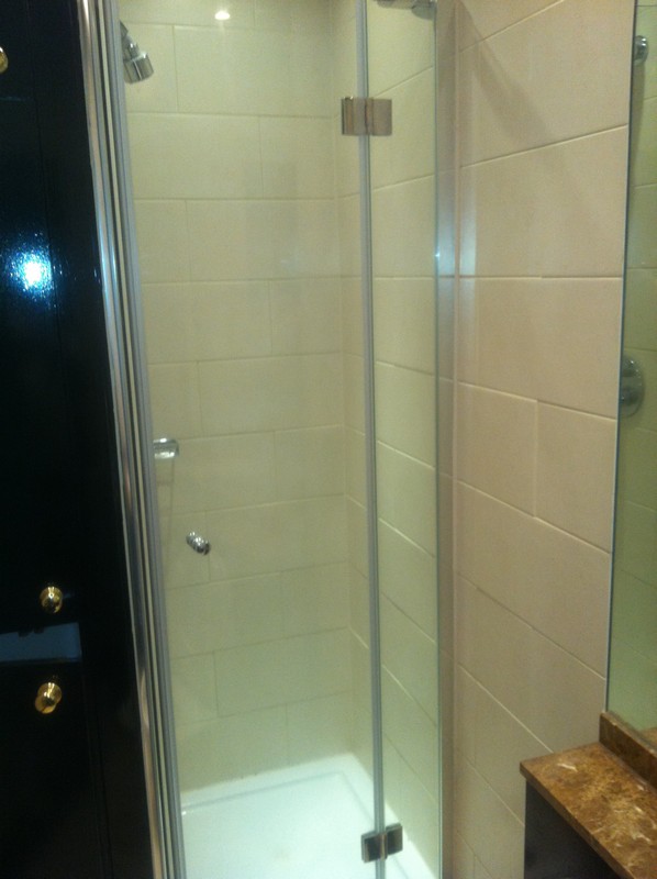 Frameless glass shower enclosure with chrome fittings in Muswell Hill
