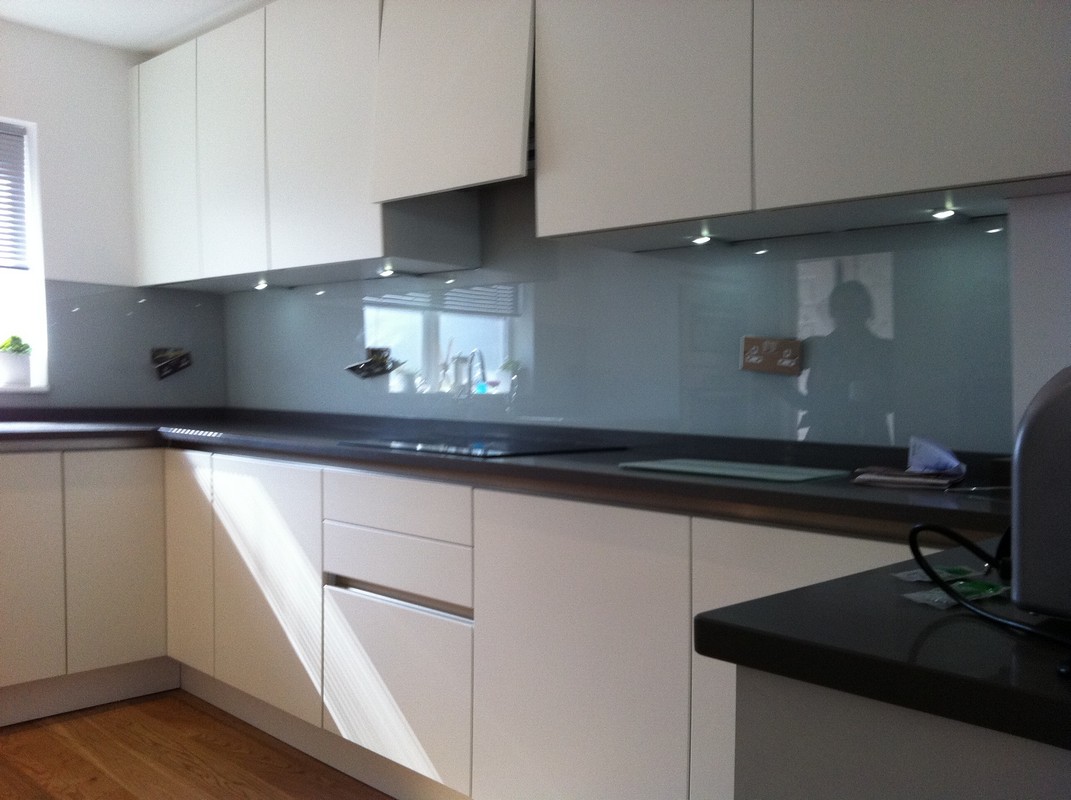 Grey glass kitchen splashback with LED lighting in Muswell Hill