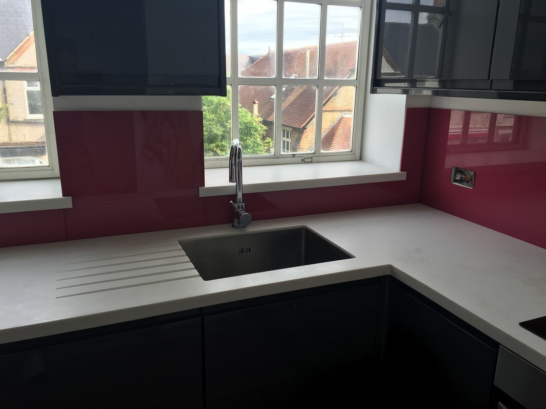Deep plum coloured glass splashback in modern Muswell Hill kitchen